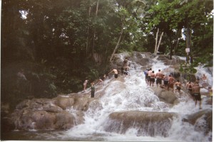 a group of people climbing a waterfall