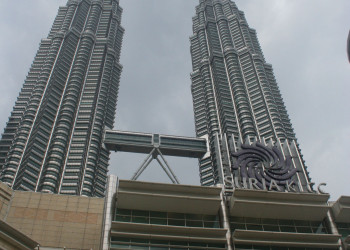 a two tall buildings with a sign on top