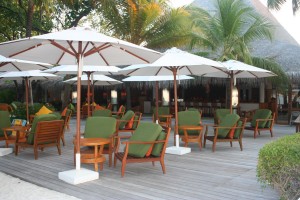 a group of chairs and umbrellas on a deck