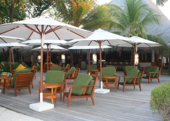 a group of chairs and umbrellas on a deck
