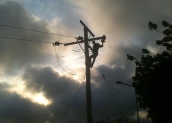 a person climbing on a power line
