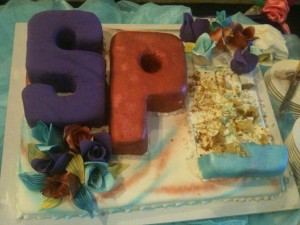 a cake with letters and flowers