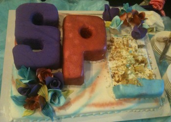 a cake with letters and flowers