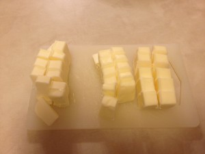 a group of cubes of butter on a cutting board