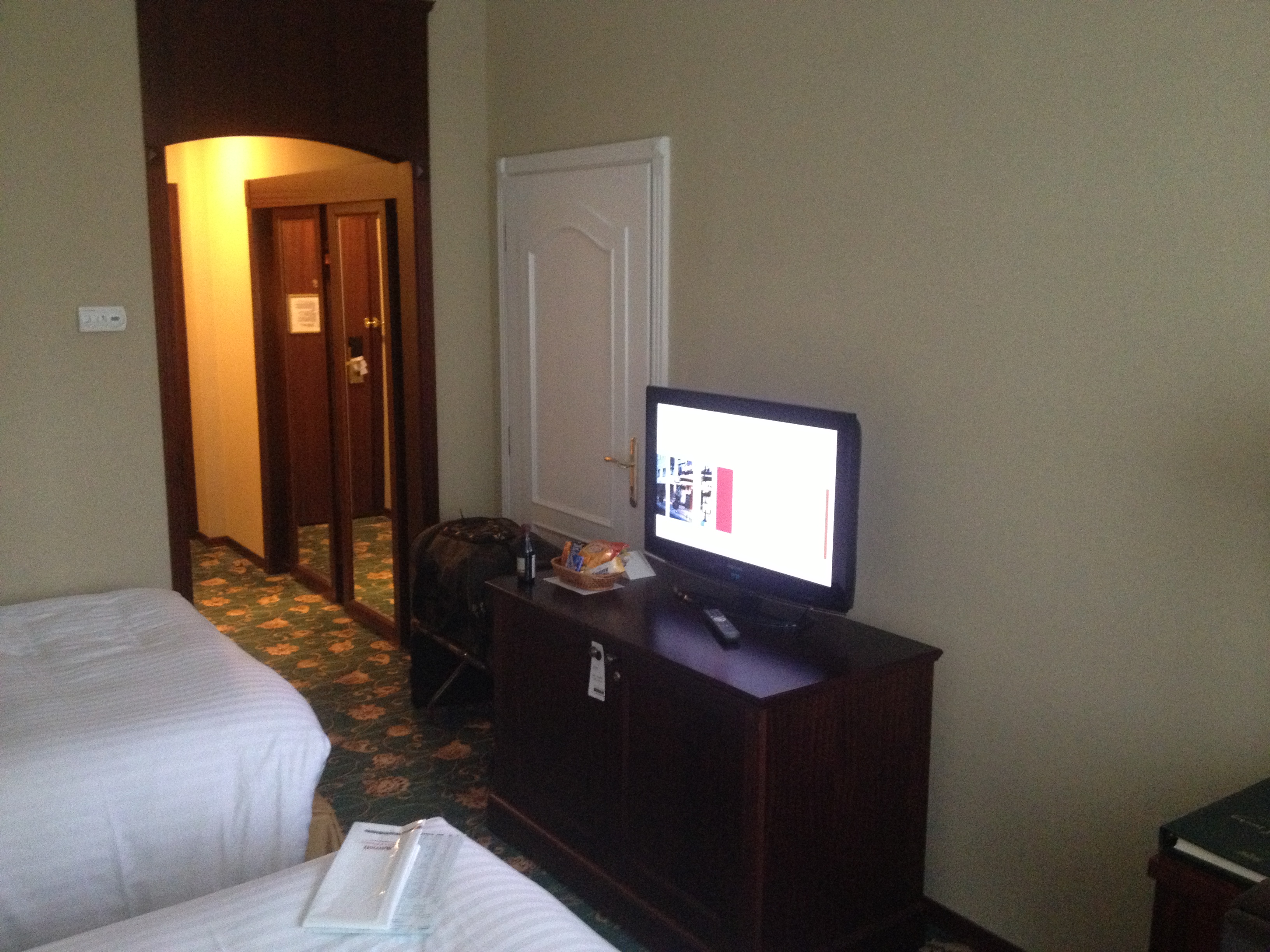 a tv on a dresser in a hotel room