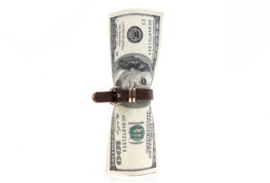 a rolled up money with a leather belt