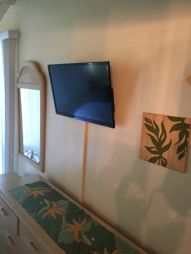 The mounted TV in the master bedroom