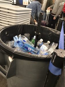 a trash can full of plastic bottles