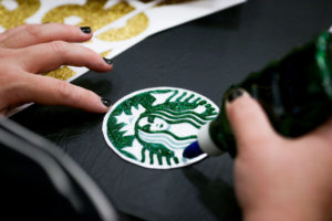 a person painting a logo