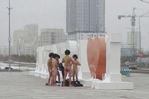 a group of naked men in swimsuits
