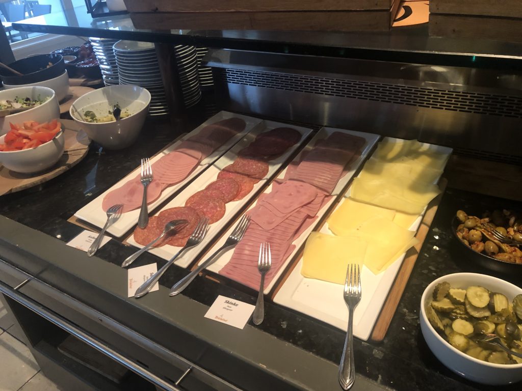 a trays of meat and cheese on a counter