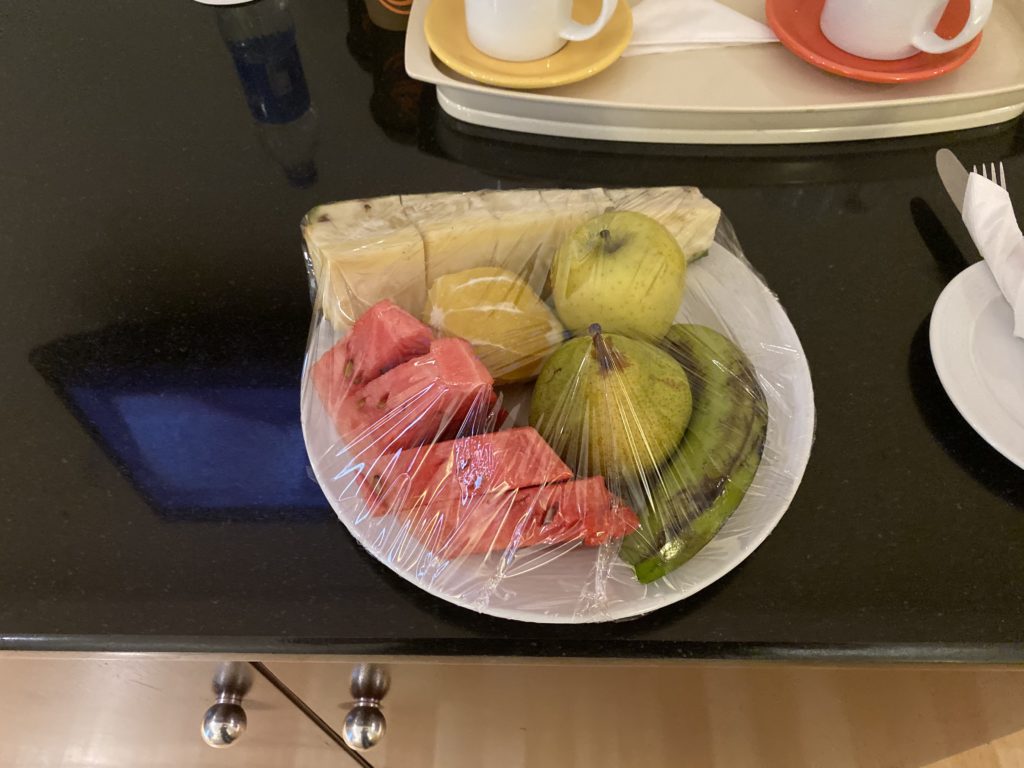 a plate of fruit wrapped in plastic
