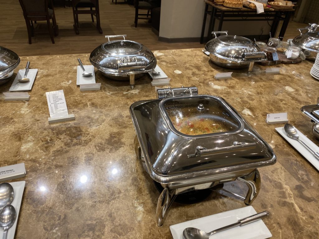 a group of silver food containers on a marble table