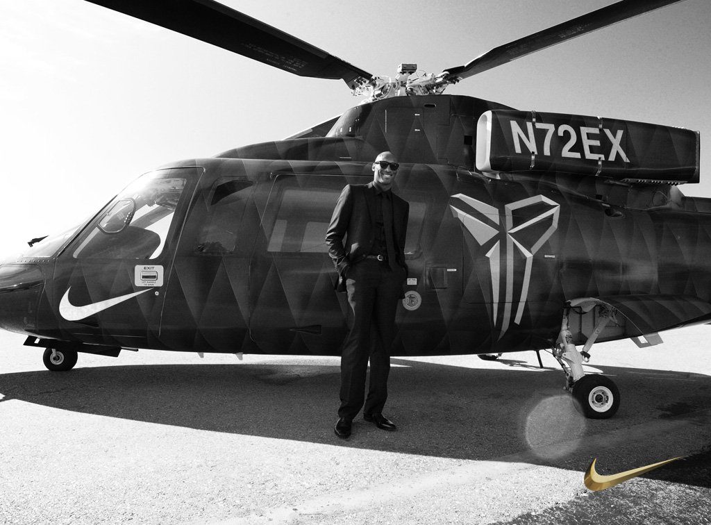 a man standing in front of a helicopter