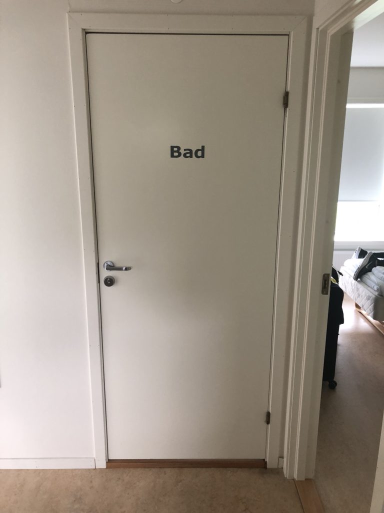 a white door with black text on it