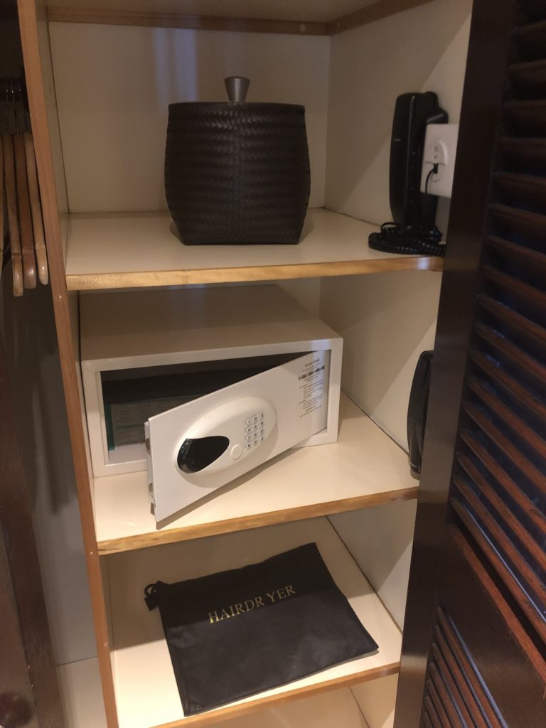 a shelf with a safe and a bag