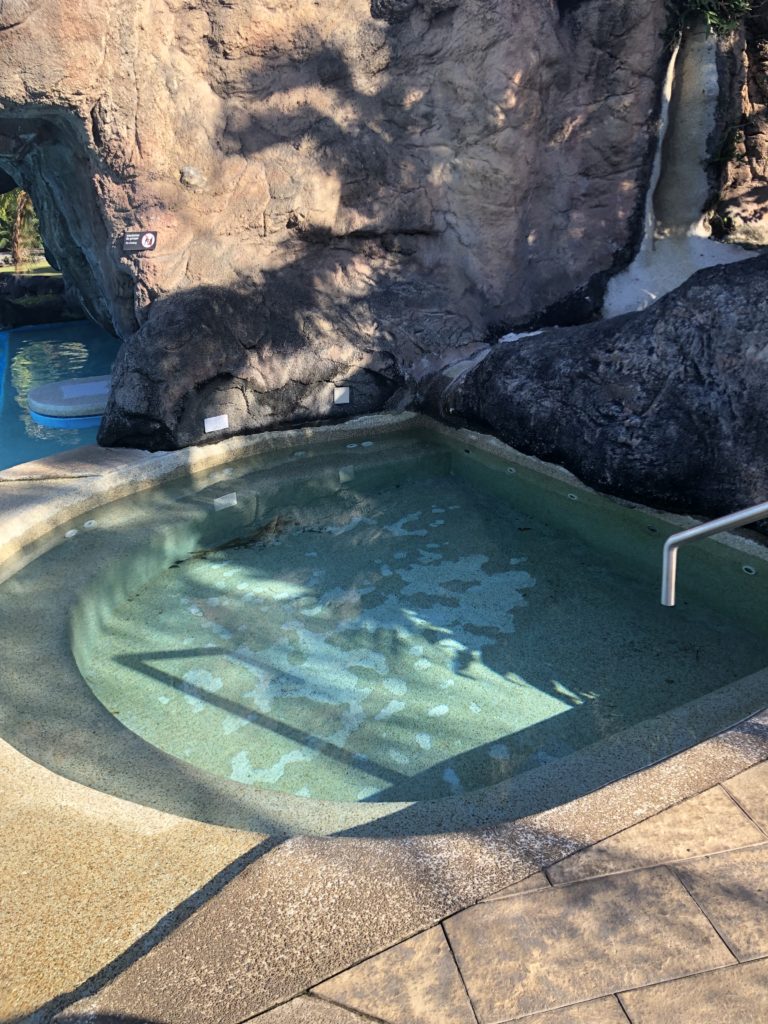 a pool with a metal railing