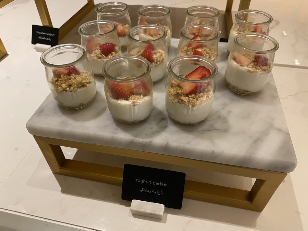 a group of jars of yogurt with strawberries and oat flakes