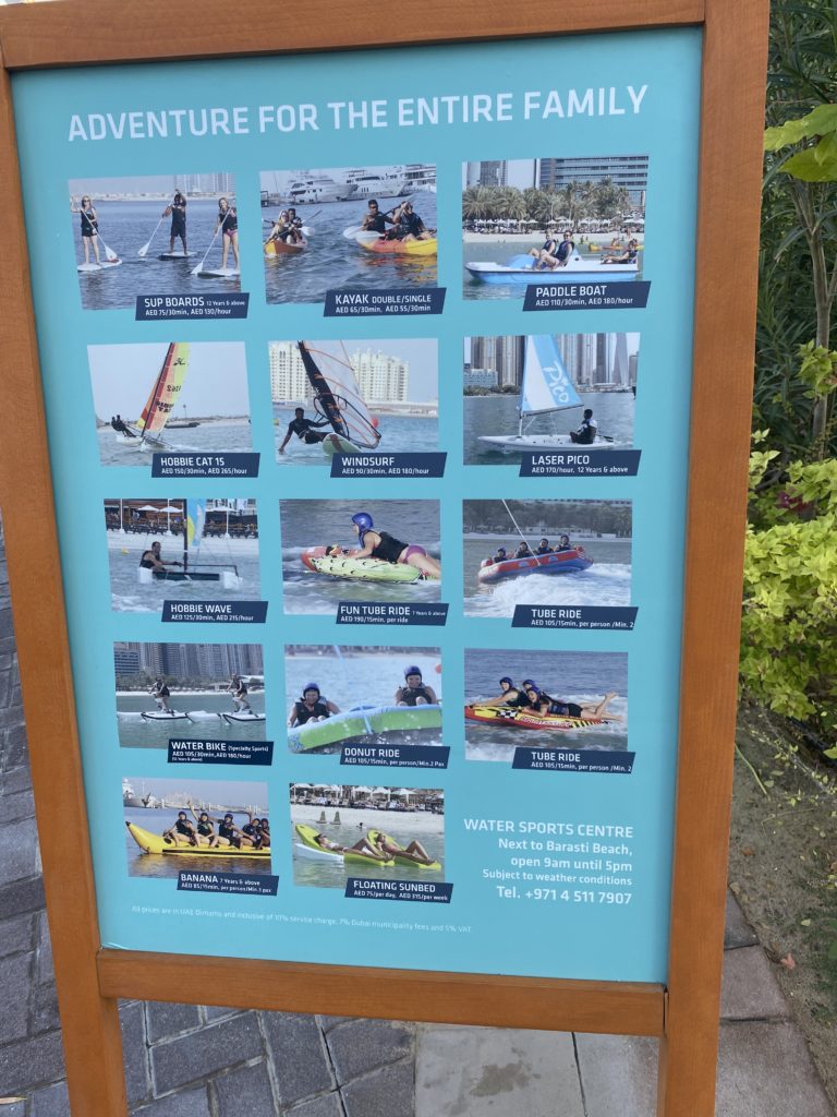 a sign with pictures of people in kayaks