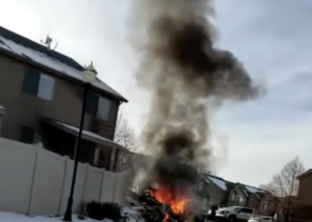 a building on fire with smoke coming out of it