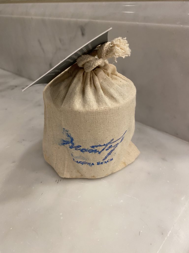 a small white bag with blue writing on it