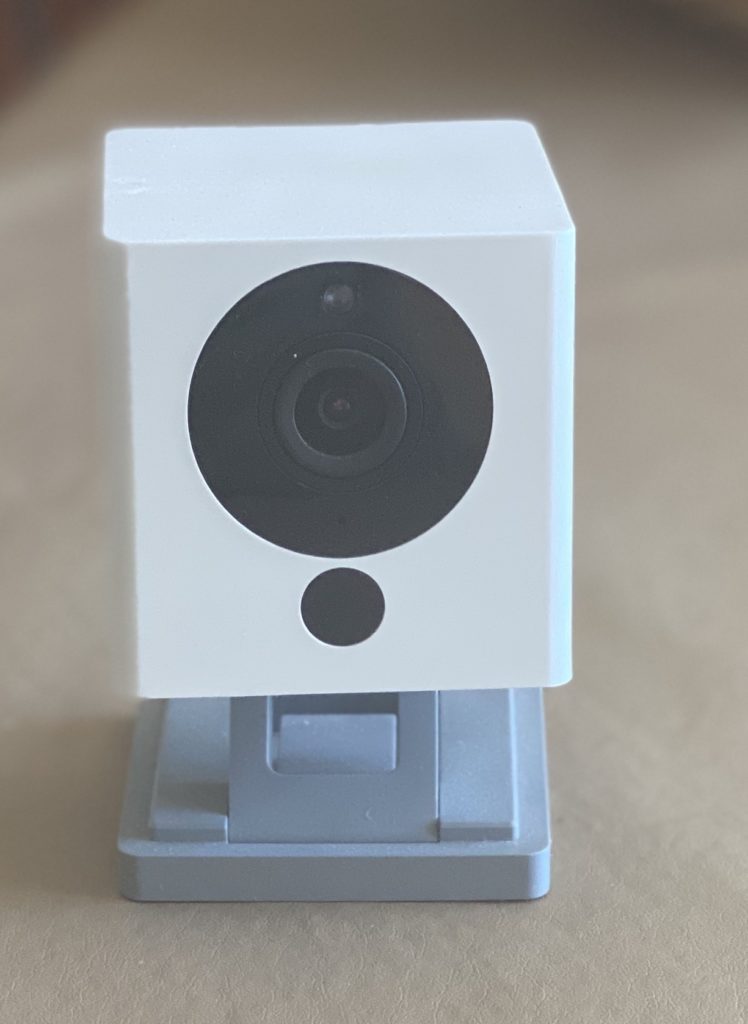a white camera on a stand