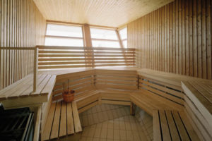 a wooden sauna with a bucket