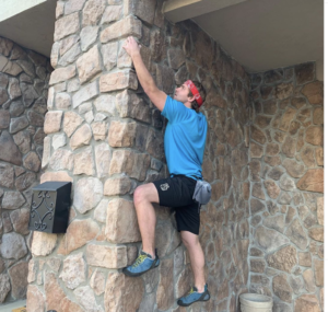 a man climbing a stone wall