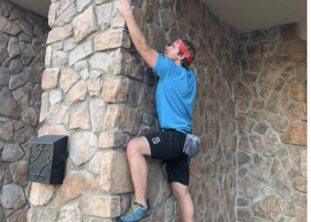 a man climbing a stone wall