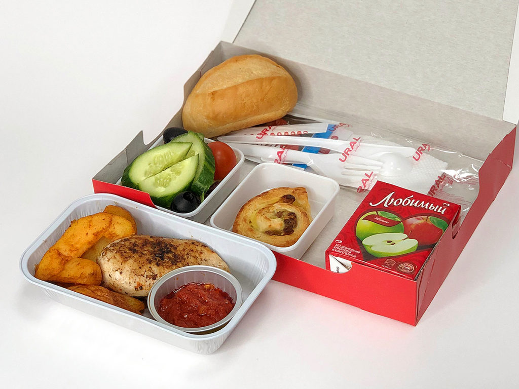 a box of food with a bread and vegetables
