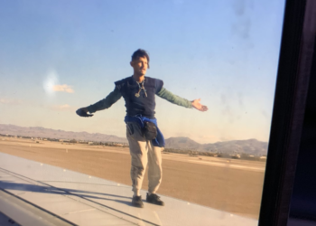 a man standing on a plane wing