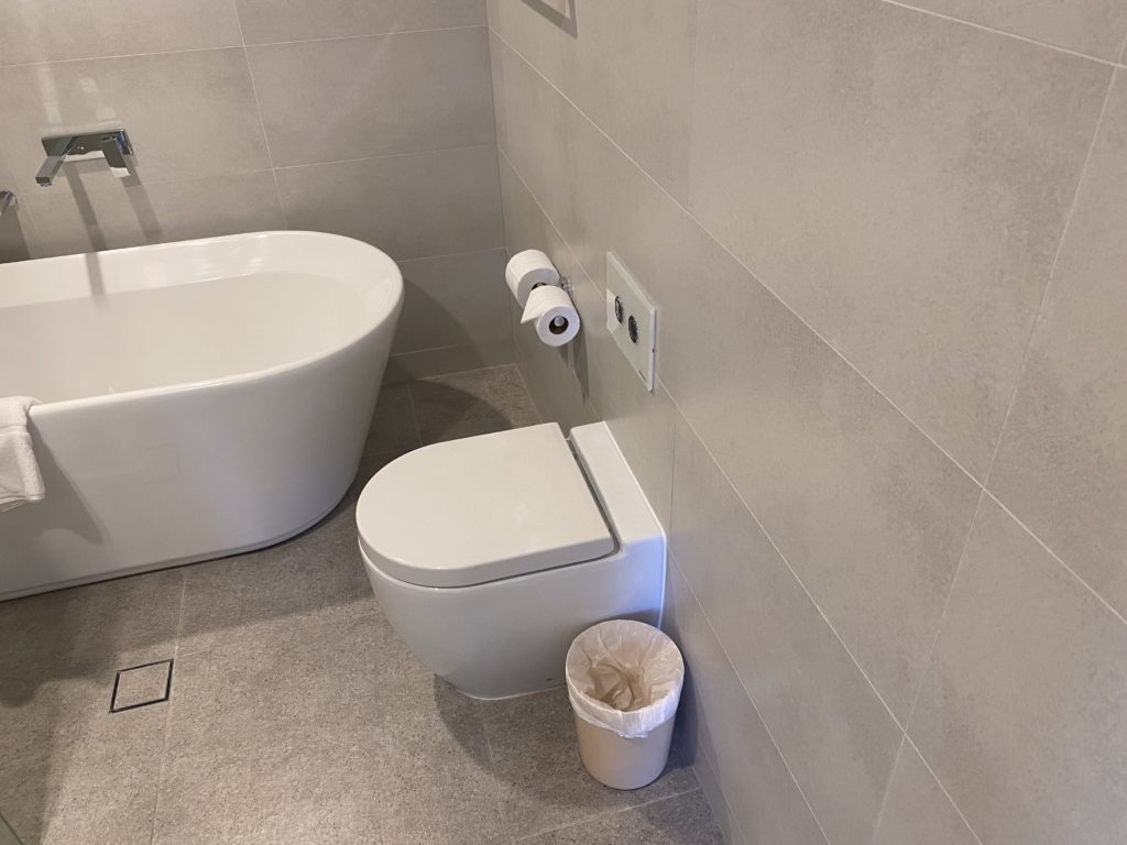 a bathroom with a toilet and a tub