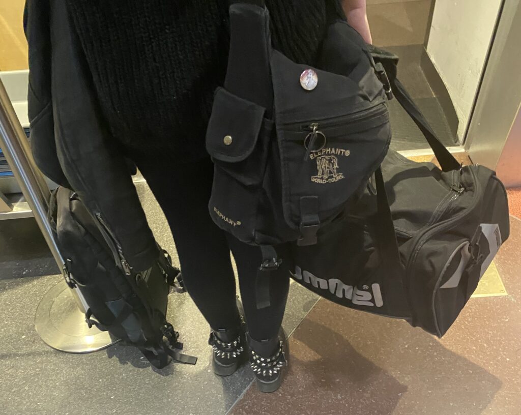 a person wearing black clothes and a backpack