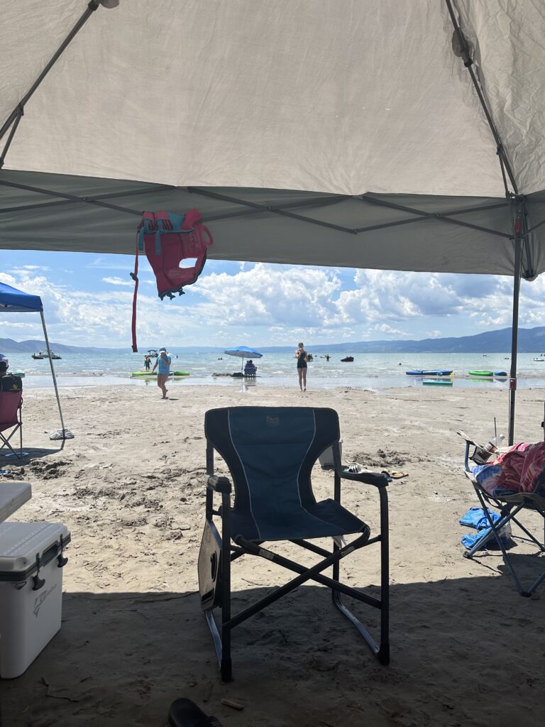 a beach with chairs and a tent